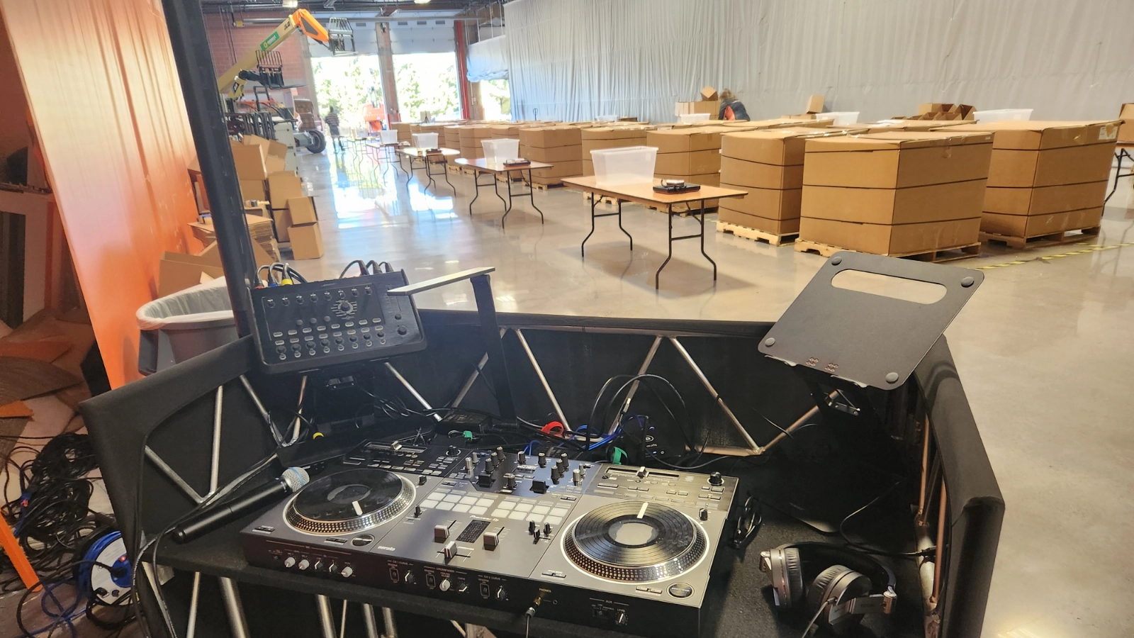 DJ Sideout control equipment positioned for event setup and production planning inside a large venue.